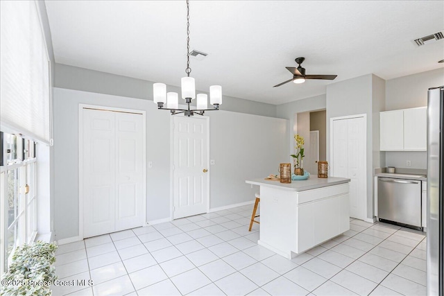 2508 Coral Ridge Cir, Melbourne, FL 32935 - kitchen featuring appliances with stainless steel finishes, white cabinets, a chandelier, light countertops, and ceiling fan