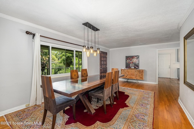 118 S Indian Cir, Cocoa, FL 32922 - dining space featuring hardwood / wood-style flooring, a chandelier, crown molding, baseboards, and a textured ceiling