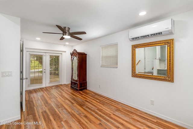 118 S Indian Cir, Cocoa, FL 32922 - unfurnished room featuring a wall unit AC, french doors, wood finished floors, ceiling fan, and recessed lighting