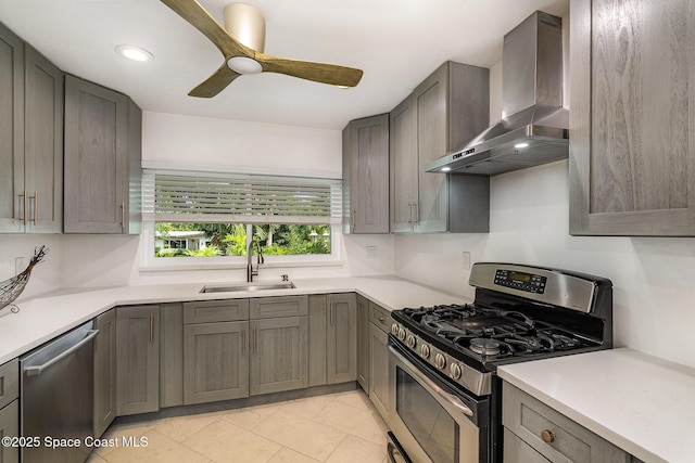 118 S Indian Cir, Cocoa, FL 32922 - kitchen with appliances with stainless steel finishes, wall chimney range hood, a sink, a ceiling fan, and light countertops