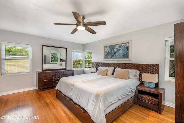118 S Indian Cir, Cocoa, FL 32922 - bedroom featuring baseboards, light wood-style floors, and multiple windows