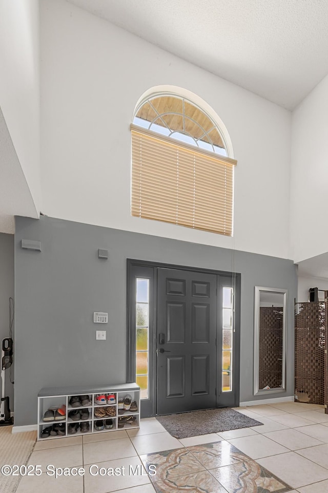 1889 Nanton St NW, Palm Bay, FL 32907 - entrance foyer with a high ceiling, inlaid floor details, and tile patterned floors