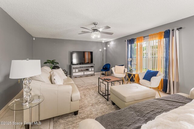 1889 Nanton St NW, Palm Bay, FL 32907 - living room featuring a ceiling fan, a textured ceiling, and tile patterned flooring