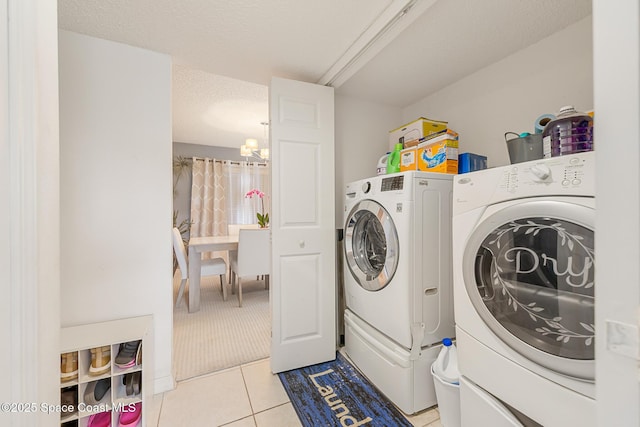 1889 Nanton St NW, Palm Bay, FL 32907 - laundry room with washing machine and dryer, light tile patterned floors, a chandelier, and a textured ceiling