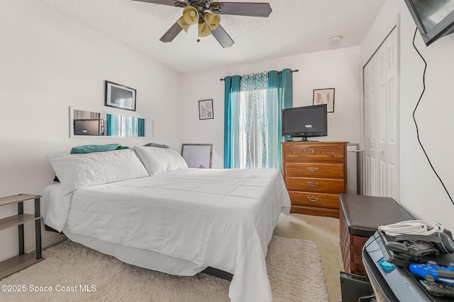 1889 Nanton St NW, Palm Bay, FL 32907 - bedroom featuring a closet, a textured ceiling, light colored carpet, and a ceiling fan