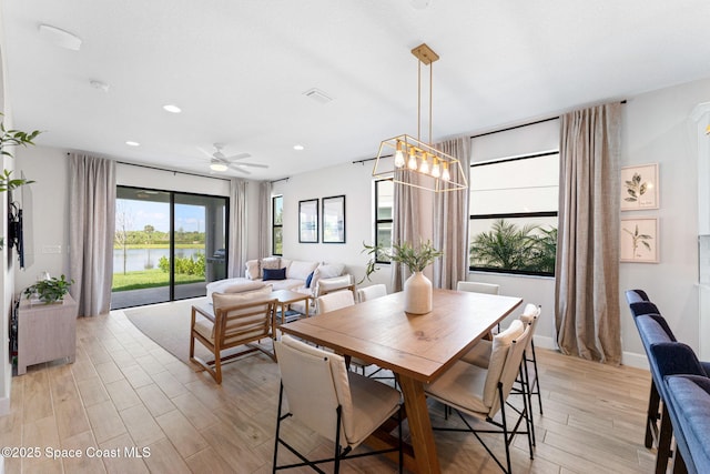 3015 Blazing Star Dr, Melbourne, FL 32940 - dining area with light wood finished floors, a ceiling fan, recessed lighting, and a water view