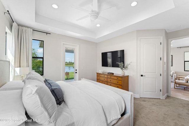 3015 Blazing Star Dr, Melbourne, FL 32940 - bedroom with access to outside, recessed lighting, light colored carpet, a tray ceiling, and ceiling fan
