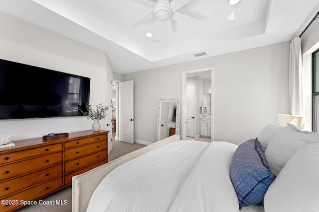 3015 Blazing Star Dr, Melbourne, FL 32940 - bedroom with a tray ceiling, carpet flooring, baseboards, recessed lighting, and ensuite bath