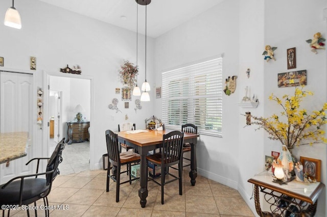 3385 Soft Breeze Cir, Melbourne, FL 32904 - dining room featuring high vaulted ceiling, light tile patterned flooring, and baseboards