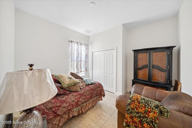 3385 Soft Breeze Cir, Melbourne, FL 32904 - bedroom featuring light tile patterned flooring, a closet, and baseboards