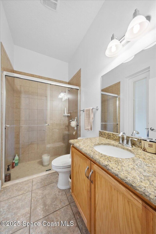 3385 Soft Breeze Cir, Melbourne, FL 32904 - bathroom with toilet, vanity, and a stall shower