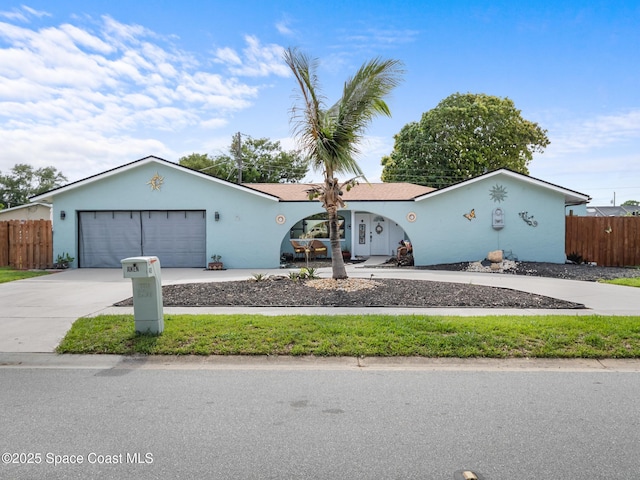 1475 Mars St, Merritt Island, FL 32953 - view of front of house featuring driveway, a garage, and stucco siding