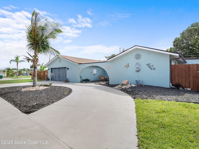 1475 Mars St, Merritt Island, FL 32953 - ranch-style house featuring stucco siding and curved driveway