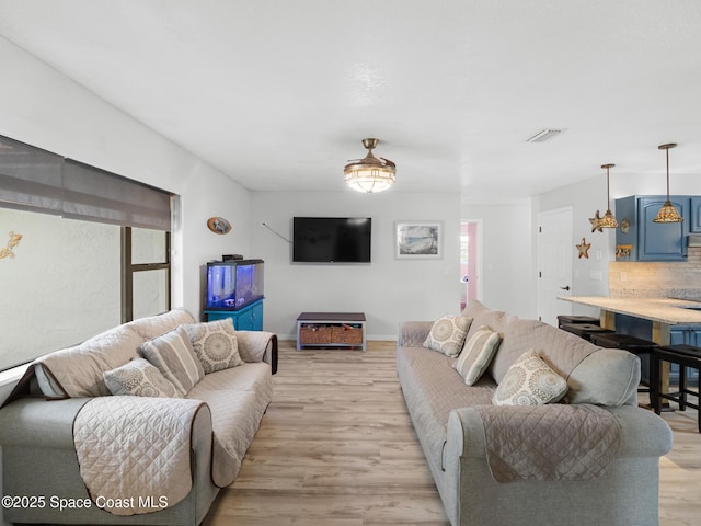 1475 Mars St, Merritt Island, FL 32953 - living room with light wood-style flooring and baseboards