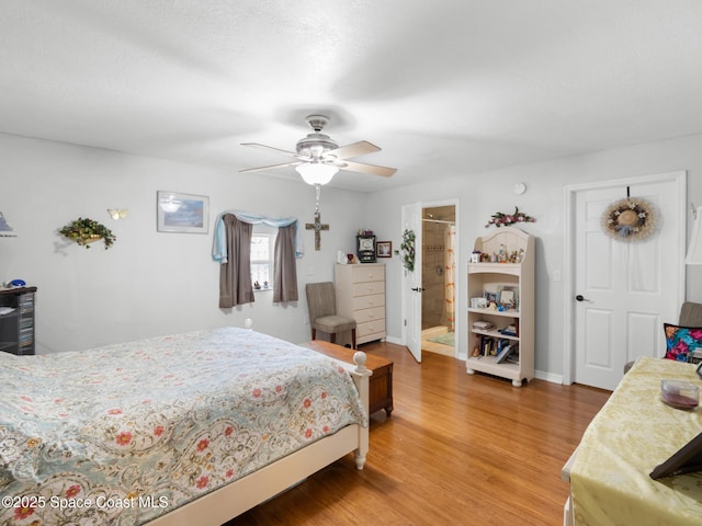 1475 Mars St, Merritt Island, FL 32953 - bedroom with light wood finished floors, a ceiling fan, baseboards, and connected bathroom