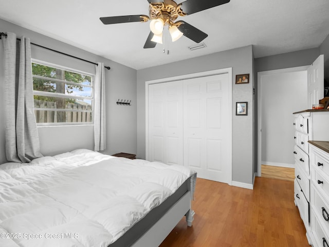 1475 Mars St, Merritt Island, FL 32953 - bedroom featuring a closet, light wood-type flooring, baseboards, and a ceiling fan