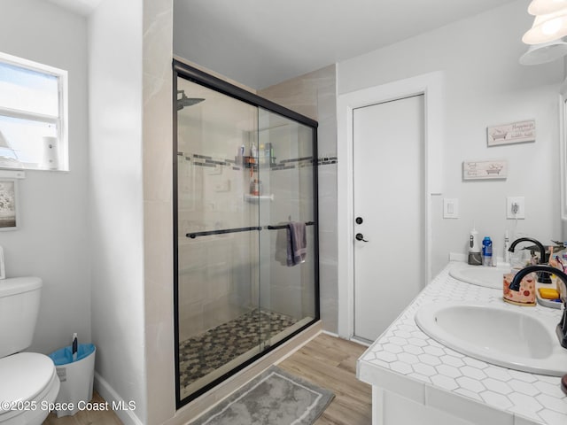 1475 Mars St, Merritt Island, FL 32953 - full bath with a stall shower, double vanity, wood finished floors, and toilet