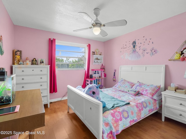 1475 Mars St, Merritt Island, FL 32953 - bedroom with wood finished floors and ceiling fan