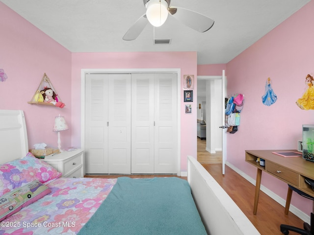 1475 Mars St, Merritt Island, FL 32953 - bedroom featuring a closet, wood finished floors, ceiling fan, and baseboards