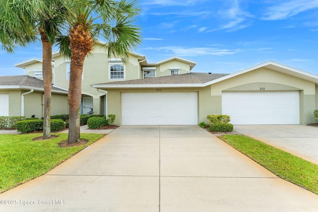 262 Prince William Ct, Satellite Beach, FL 32937 - view of front of home featuring stucco siding, driveway, and a front lawn