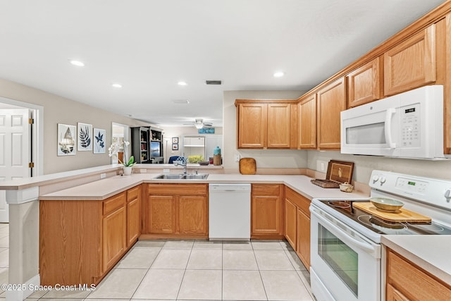 262 Prince William Ct, Satellite Beach, FL 32937 - kitchen with white appliances, a peninsula, light countertops, light tile patterned floors, and recessed lighting