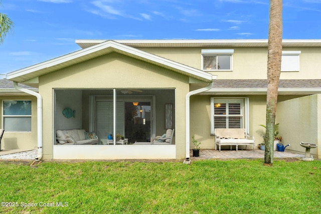 262 Prince William Ct, Satellite Beach, FL 32937 - rear view of house with a sunroom, stucco siding, and a yard