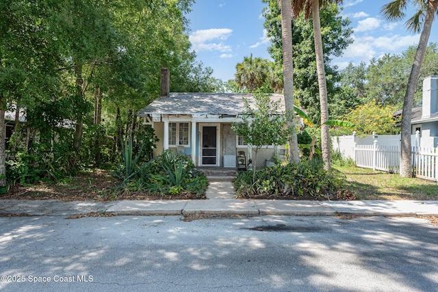 213 Sweet St, Rockledge, FL 32955 - view of front of home with stucco siding and a chimney