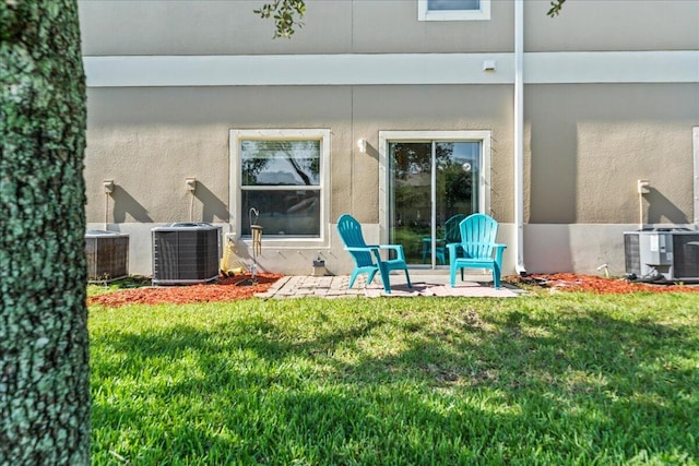 2500 Revolution St Unit 103, Melbourne, FL 32935 - back of house with central air condition unit, a yard, and a patio area