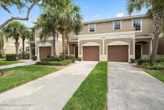 2500 Revolution St Unit 103, Melbourne, FL 32935 - multi unit property featuring stucco siding, driveway, and a front lawn