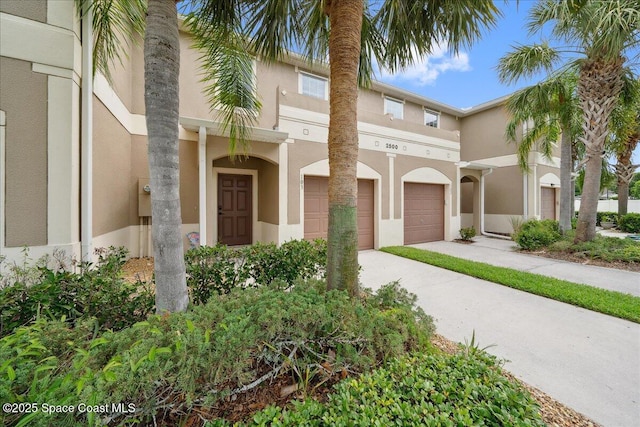 2500 Revolution St Unit 103, Melbourne, FL 32935 - townhome / multi-family property featuring driveway, a garage, and stucco siding