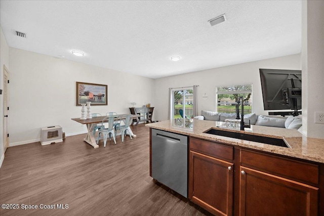 2500 Revolution St Unit 103, Melbourne, FL 32935 - kitchen featuring dishwasher, a sink, dark wood-type flooring, open floor plan, and light stone counters