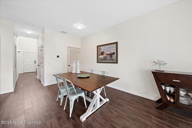 2500 Revolution St Unit 103, Melbourne, FL 32935 - dining space with dark wood-style floors and baseboards