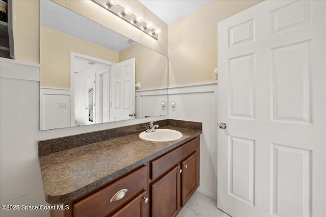 2500 Revolution St Unit 103, Melbourne, FL 32935 - bathroom featuring vanity and wainscoting