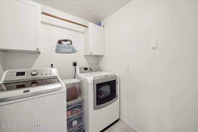 2500 Revolution St Unit 103, Melbourne, FL 32935 - laundry area featuring washer and dryer, cabinet space, and baseboards