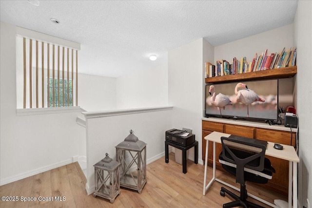 2500 Revolution St Unit 103, Melbourne, FL 32935 - office space featuring light wood-style floors, a textured ceiling, and baseboards