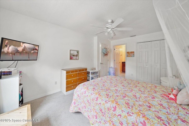 2500 Revolution St Unit 103, Melbourne, FL 32935 - bedroom with a closet, carpet, baseboards, ceiling fan, and a textured ceiling