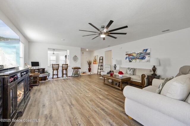 4554 Magenta Isles Dr, Melbourne, FL 32904 - living area featuring wood finished floors and a ceiling fan