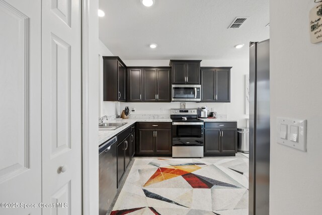 4554 Magenta Isles Dr, Melbourne, FL 32904 - kitchen with stainless steel appliances, a sink, light countertops, and recessed lighting