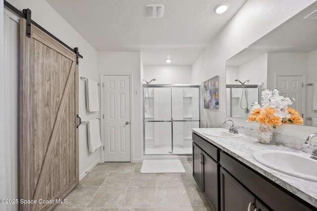 4554 Magenta Isles Dr, Melbourne, FL 32904 - full bath with a shower stall, double vanity, and a textured ceiling