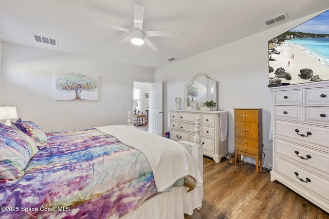 4554 Magenta Isles Dr, Melbourne, FL 32904 - bedroom with dark wood-type flooring, ceiling fan, and a water view