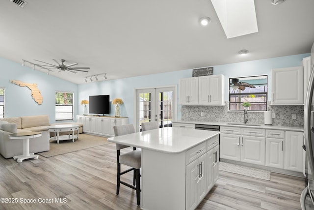 149 Kyle Ct NE, Palm Bay, FL 32907 - kitchen featuring a sink, open floor plan, french doors, light countertops, and a ceiling fan