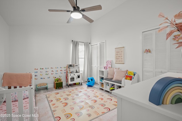 149 Kyle Ct NE, Palm Bay, FL 32907 - bedroom with two closets, lofted ceiling, a ceiling fan, a crib, and wood finished floors