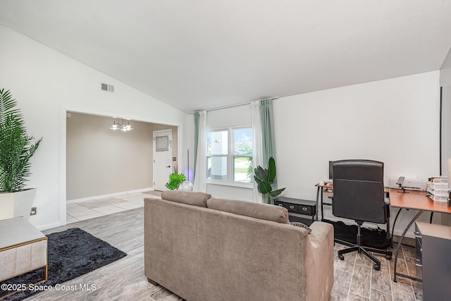 5145 Fay Blvd, Cocoa, FL 32927 - living area with a chandelier, lofted ceiling, a desk, light wood-style flooring, and baseboards