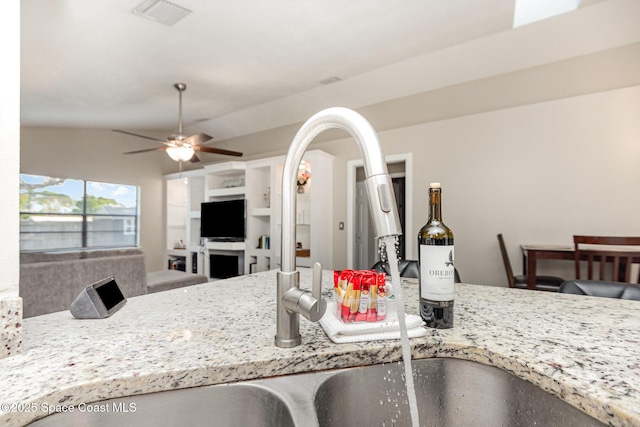 5145 Fay Blvd, Cocoa, FL 32927 - kitchen featuring a sink, a ceiling fan, light stone countertops, and open floor plan