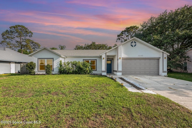 5145 Fay Blvd, Cocoa, FL 32927 - ranch-style home with a garage, driveway, stucco siding, and a lawn
