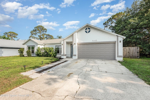 5145 Fay Blvd, Cocoa, FL 32927 - ranch-style home featuring stucco siding, an attached garage, and driveway