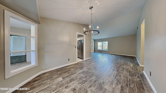 5145 Fay Blvd, Cocoa, FL 32927 - empty room with a chandelier, wood finished floors, and baseboards