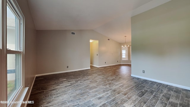 5145 Fay Blvd, Cocoa, FL 32927 - empty room with a chandelier, lofted ceiling, dark wood-style floors, and baseboards