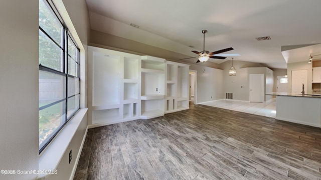 5145 Fay Blvd, Cocoa, FL 32927 - unfurnished living room with lofted ceiling, ceiling fan, light wood-style flooring, and baseboards
