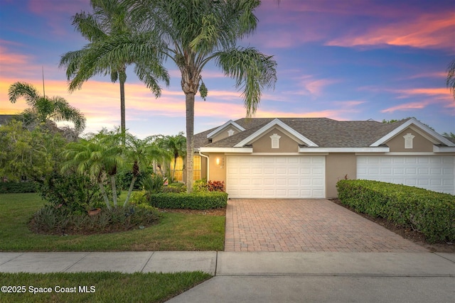 4341 Aberdeen Cir, Rockledge, FL 32955 - view of front of home with stucco siding, decorative driveway, and a garage